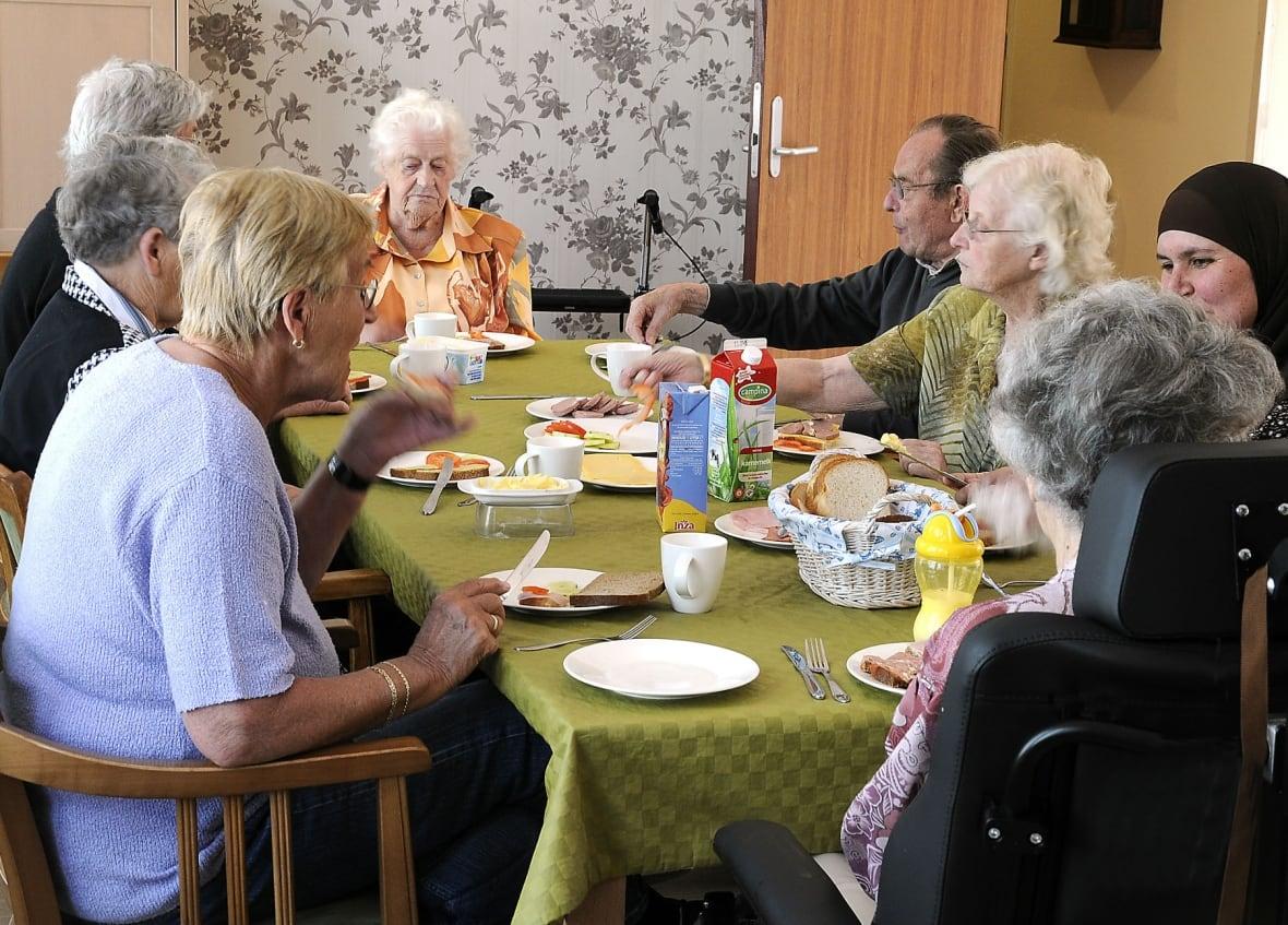 People eating around a dining table